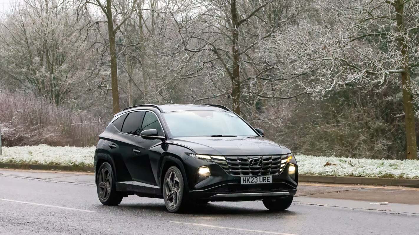 A black Hyundai SUV on a winter road.