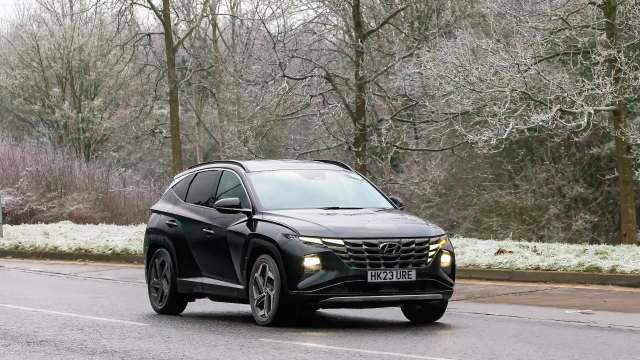 A black Hyundai SUV on a winter road.