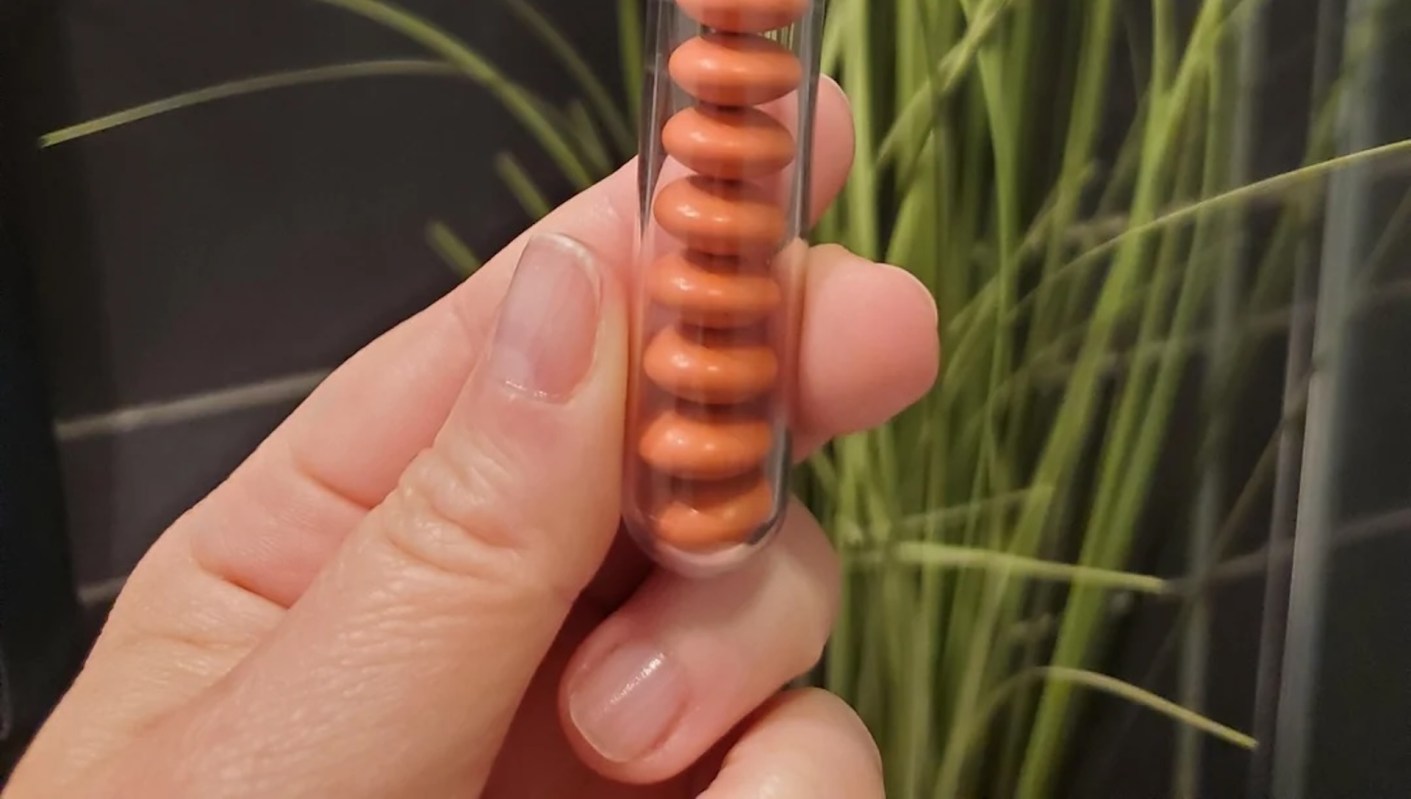 A person holds a transparent tube with ibuprofen.