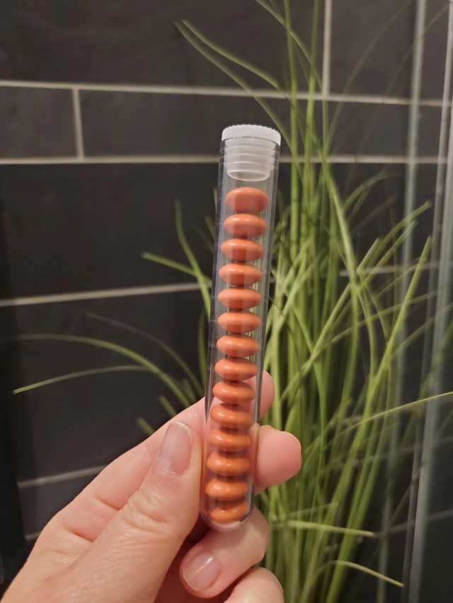 A person holds a transparent tube with ibuprofen.