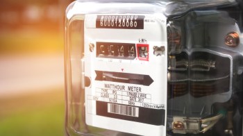 A close-up view of an electric watt-hour meter displaying usage readings and specifications.