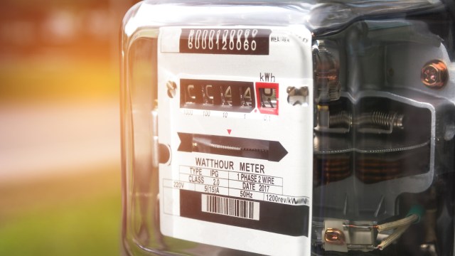 A close-up view of an electric watt-hour meter displaying usage readings and specifications.