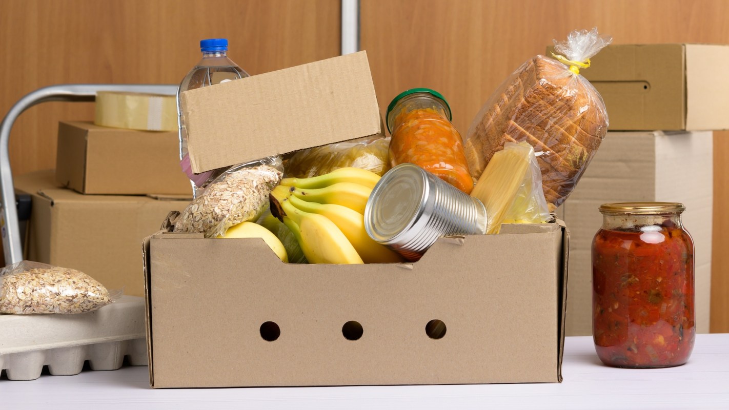 A cardboard box filled with food items.