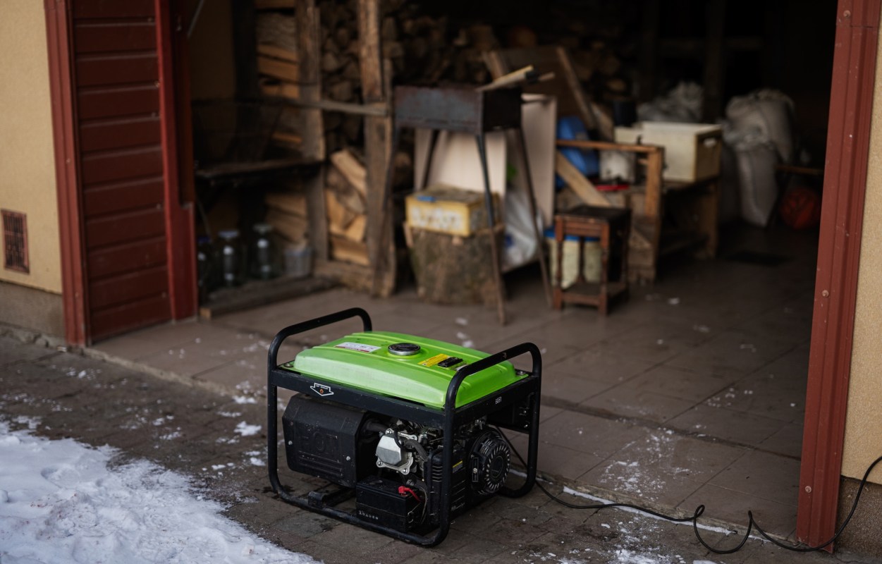 A portable generator outside a storage area.