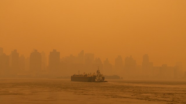 A cargo ship shrouded in hazy wildfire smoke.