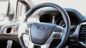 The Ford logo on a steering wheel.