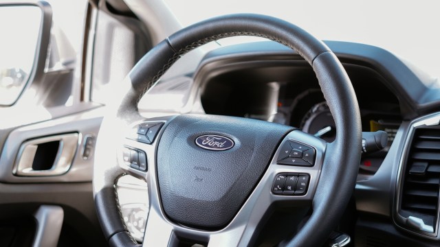 The Ford logo on a steering wheel.
