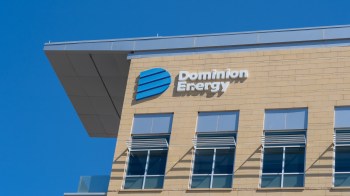 A building facade featuring the Dominion Energy logo against a clear blue sky.