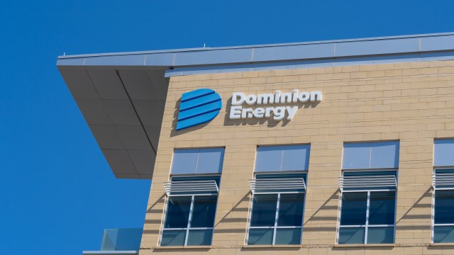 A building facade featuring the Dominion Energy logo against a clear blue sky.