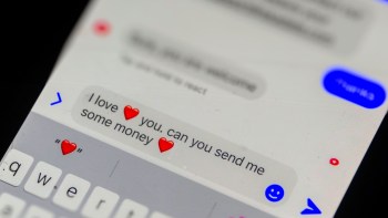 A close-up of a text message reading "I love ❤️ you. can you send me some money ❤️" on a smartphone screen.