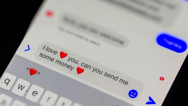 A close-up of a text message reading "I love ❤️ you. can you send me some money ❤️" on a smartphone screen.