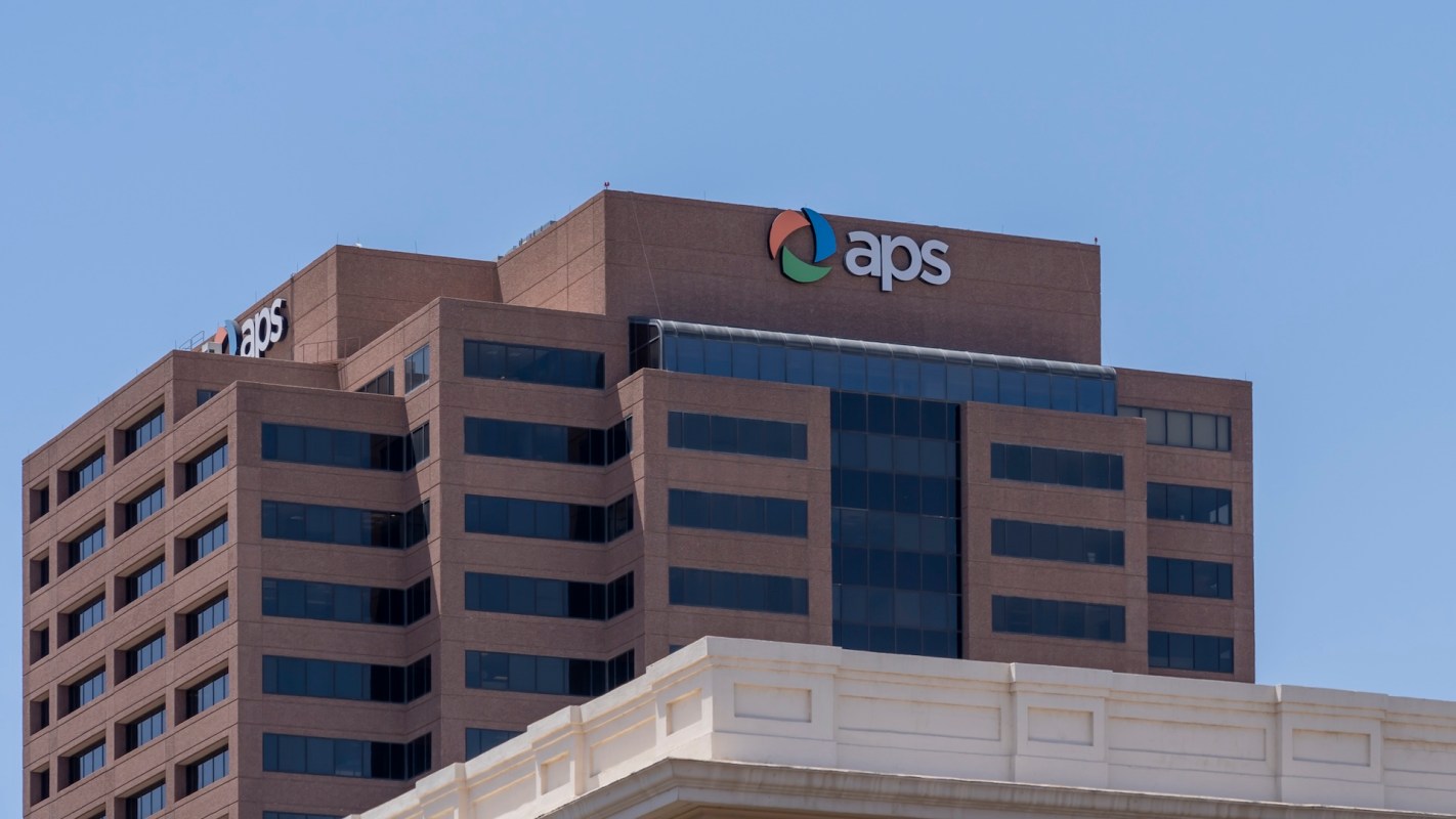 A close-up view of the APS building with a clear blue sky in the background.