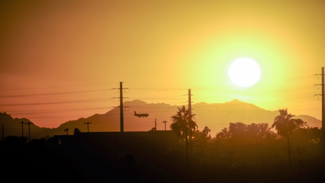An airplane landing in Arizona at sunset.