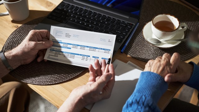 Two people reviewing a utility bill.