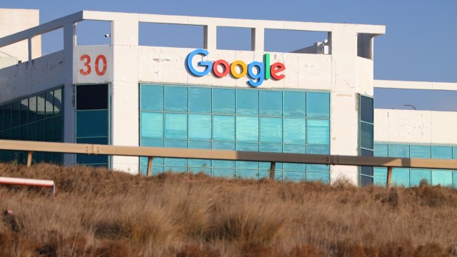 A Google office building with large blue windows and the number 30 visible on the side.
