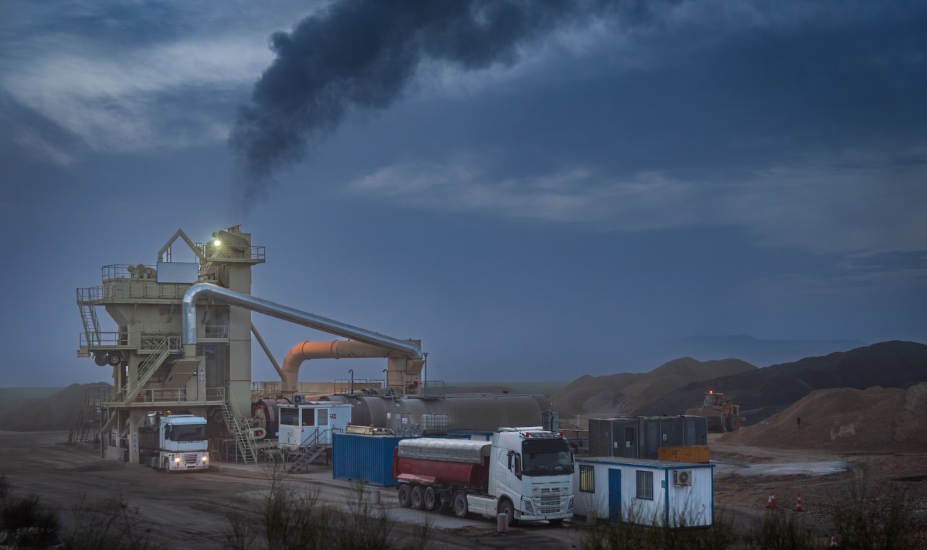 An industrial facility spewing black smoke.