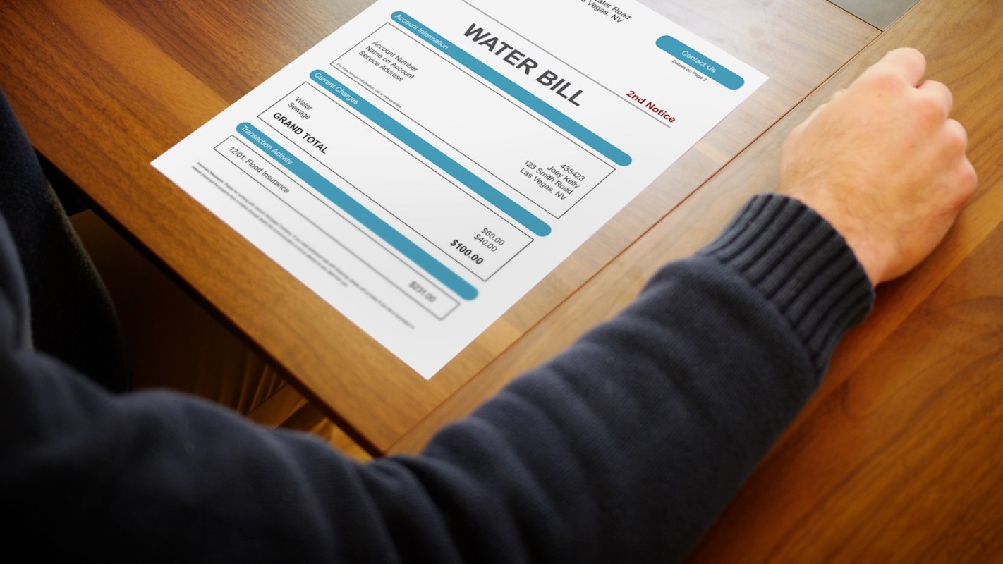 A person looking at a water bill.