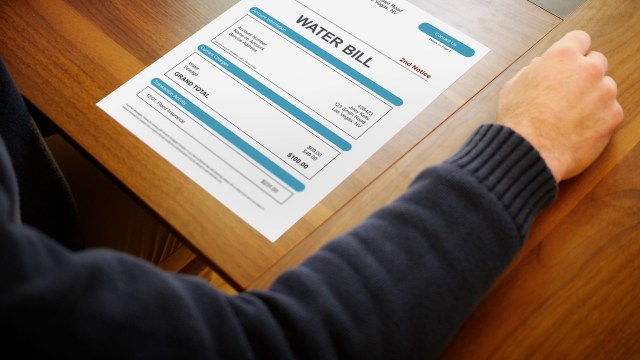 A person looking at a water bill.