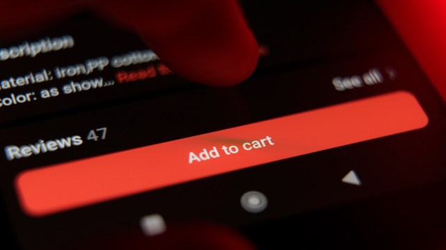 A finger poised to click the "Add to cart" button on a smartphone screen displaying product details.