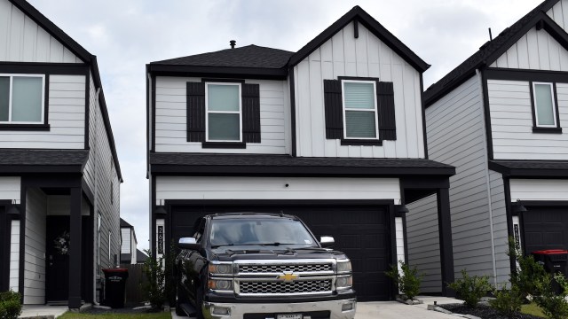 A truck in front of a condo.