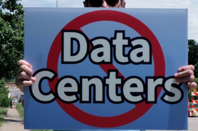A protestor holding an anti-data center sign.