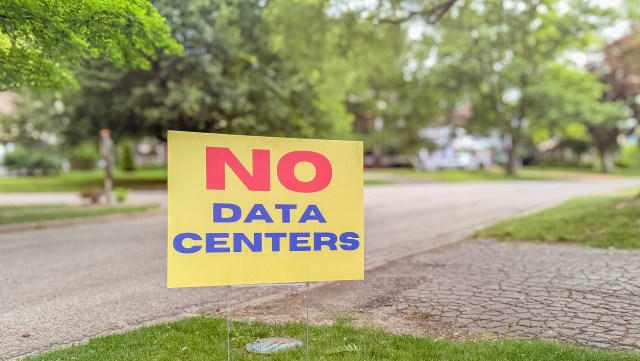 An anti-data center sign in a residential yard.