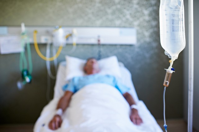 A patient with an IV in a hospital bed.