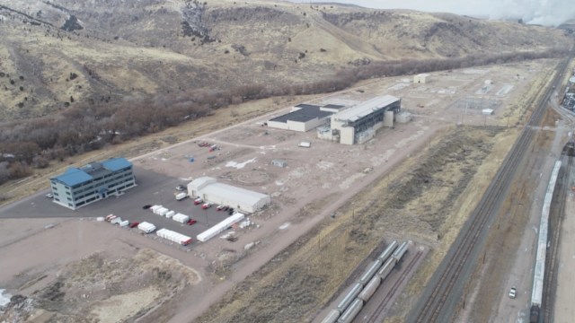 An aerial view of a sprawling industrial area in the mountains.