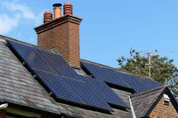 A house with rooftop solar panels.