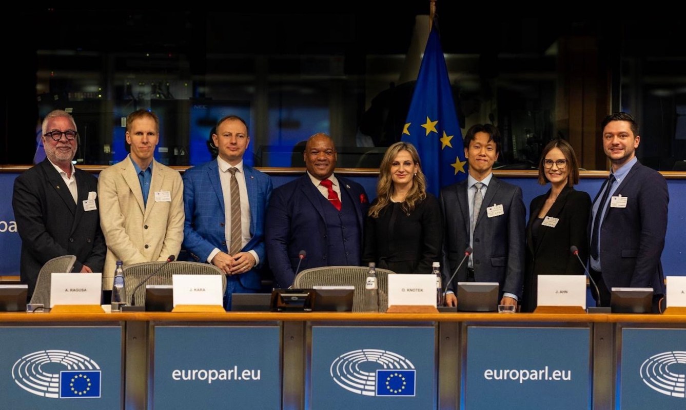 Eight attendees at a conference at the European Parliament.