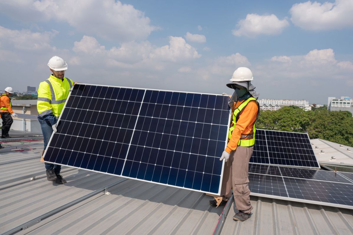 Installing solar panels on a roof.
