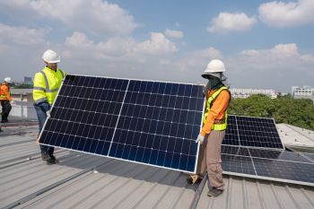 Installing solar panels on a roof.