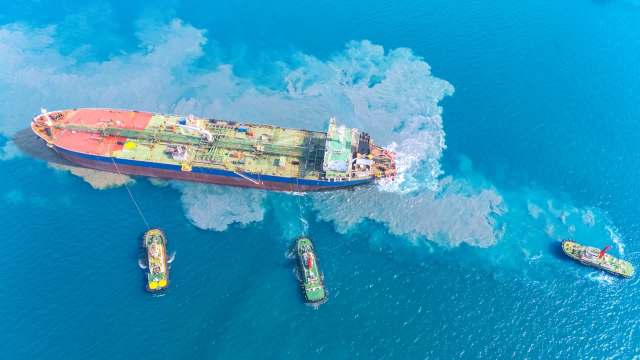 An oil tanker and three tugboats.