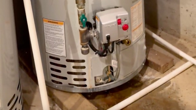 A puddle near a gas water heater.
