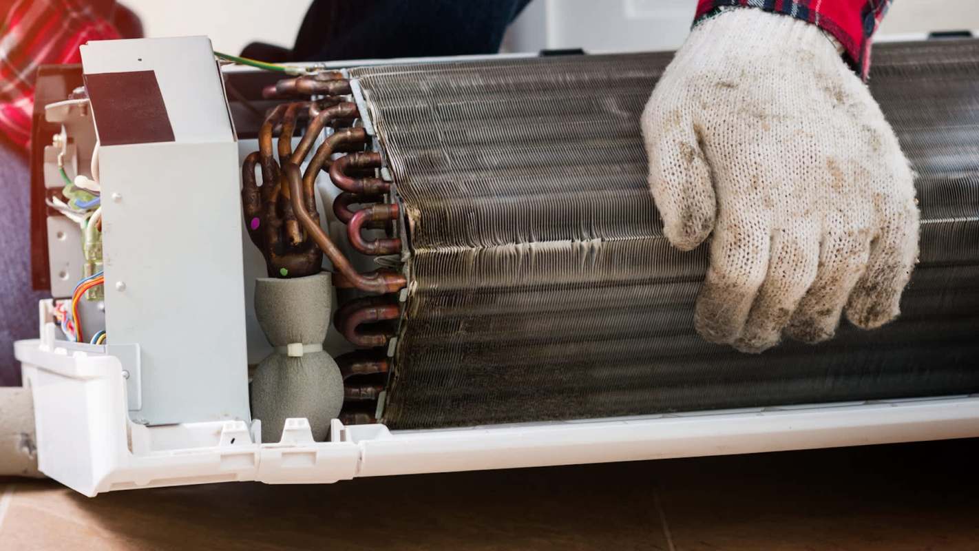 A glove on top of an AC coil.