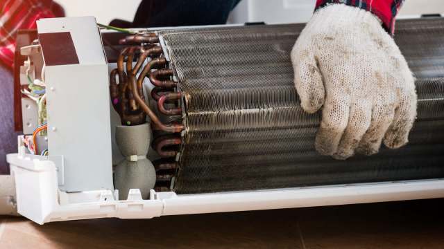 A glove on top of an AC coil.