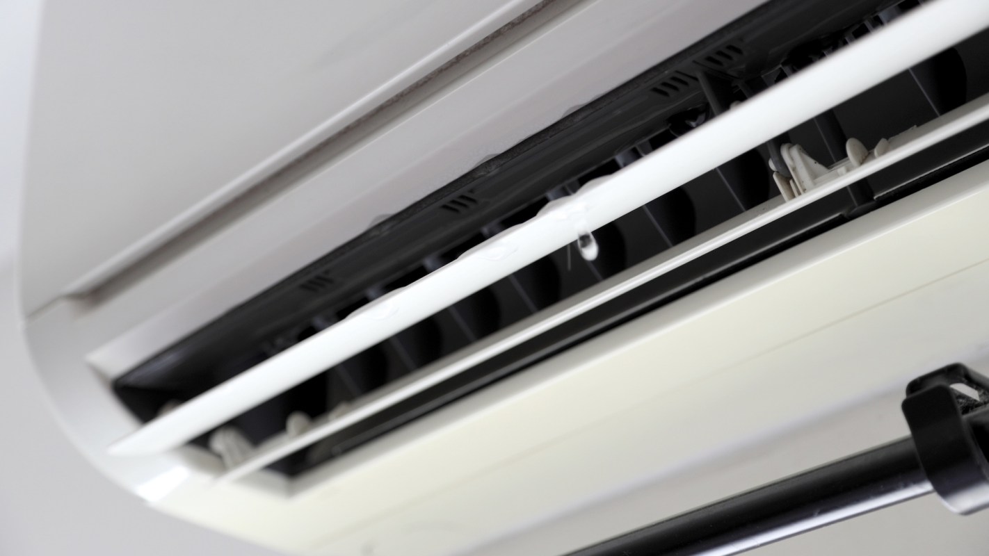 A close-up view of an air conditioning unit with visible moisture droplets.