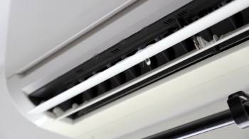 A close-up view of an air conditioning unit with visible moisture droplets.