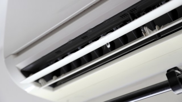 A close-up view of an air conditioning unit with visible moisture droplets.