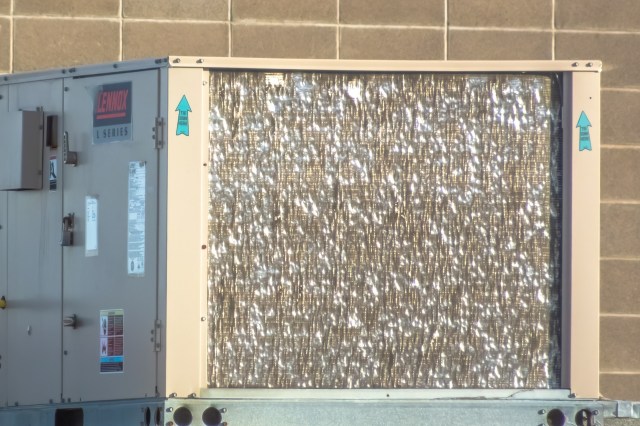 A Lennox air conditioning unit with a reflective panel.
