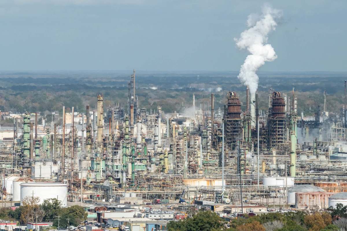 An oil refinery releasing pollution into the air.