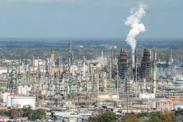 An oil refinery releasing pollution into the air.