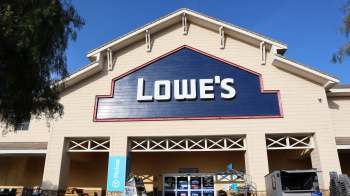 The storefront of a Lowe's home improvement store with a blue sign and clear blue sky in the background.