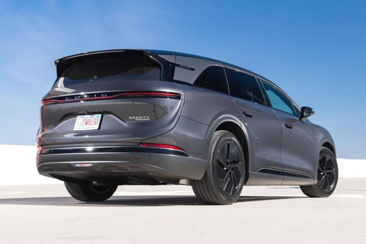 A sleek gray Lucid Gravity SUV parked against a clear blue sky.