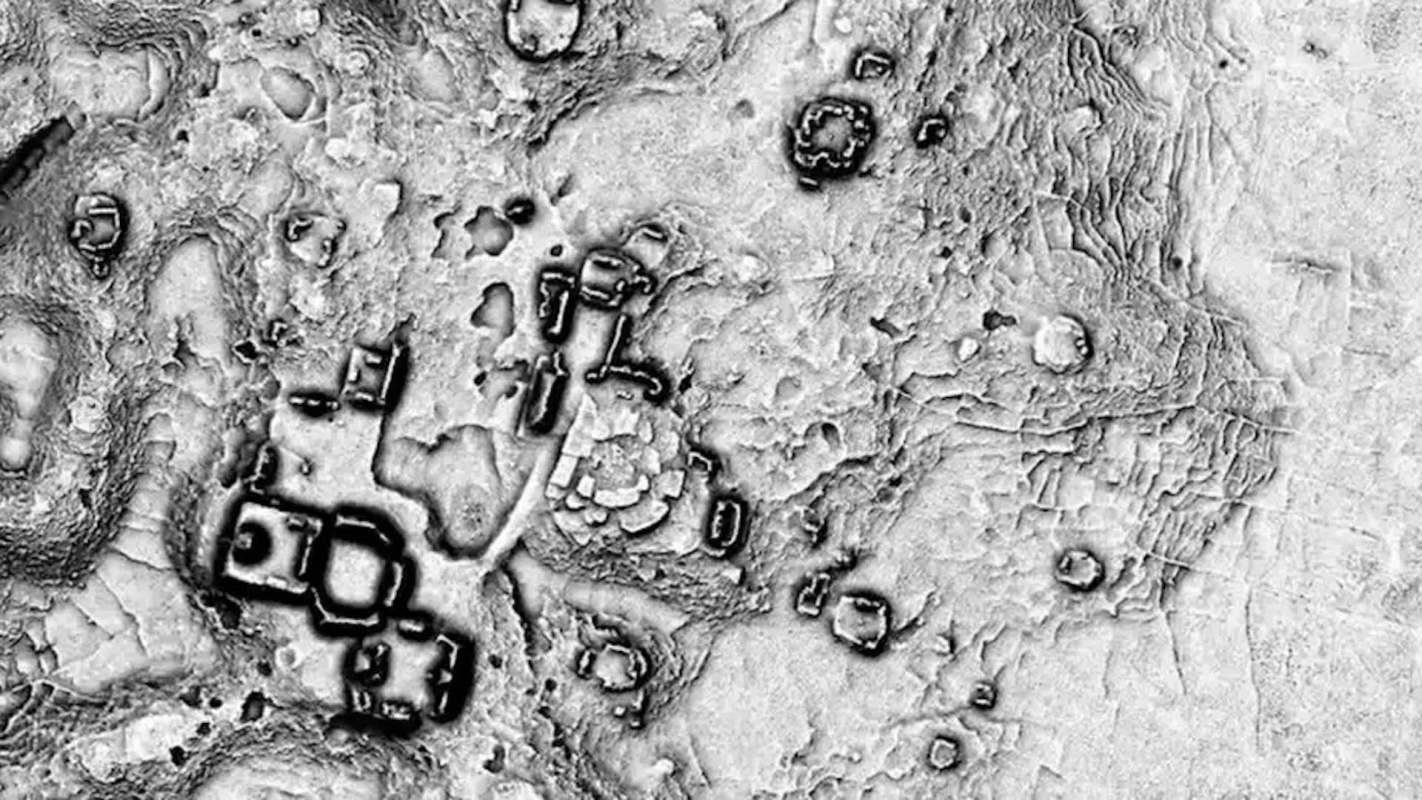 A monochrome aerial view showing ancient structures and terrain features on an archaeological site.