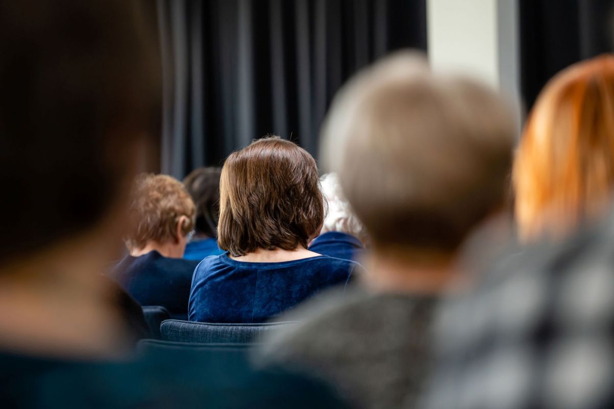 A group of people sitting in a meeting.