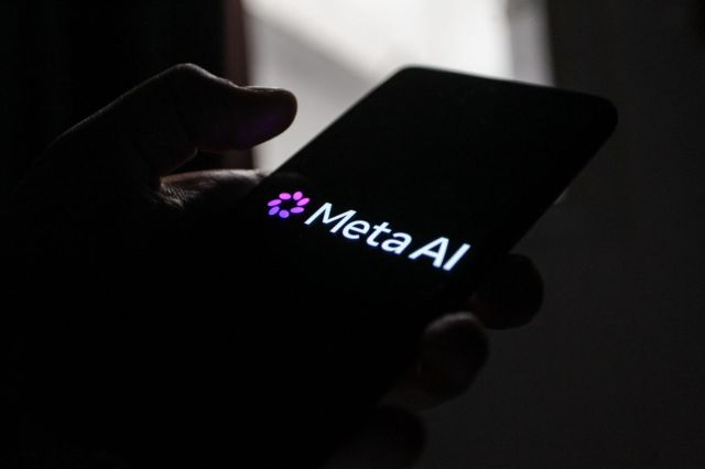 A Meta AI logo on a smartphone.
