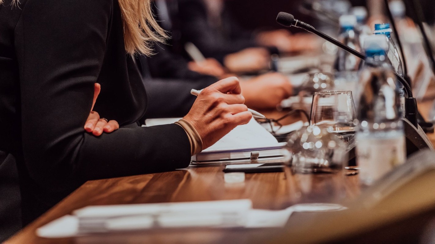 A person taking notes at a meeting.