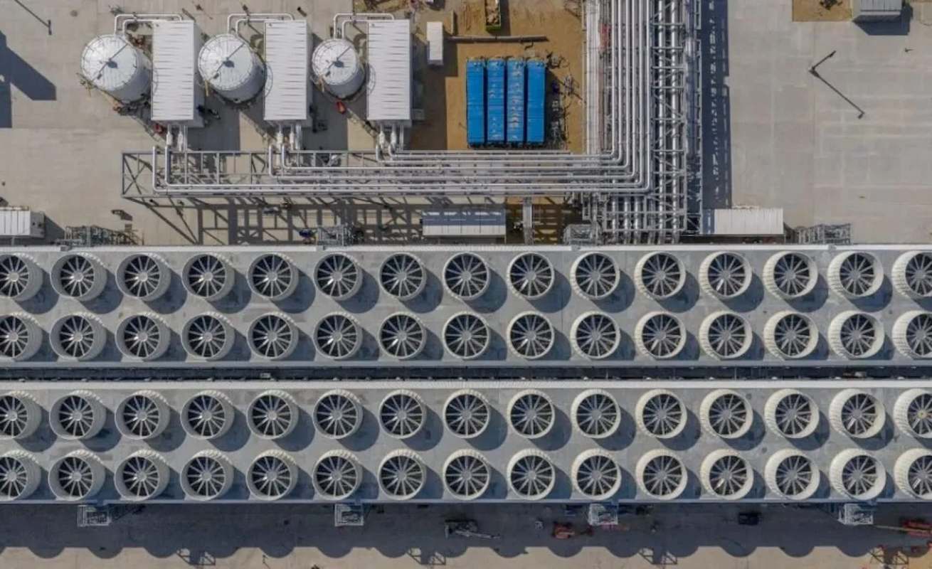An aerial view of an industrial facility with rows of cooling fans.