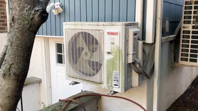 An outdoor air conditioning unit showing signs wear.